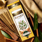 Deluxe Sandal Agarbatti Pack surrounded by sandalwood and leaves