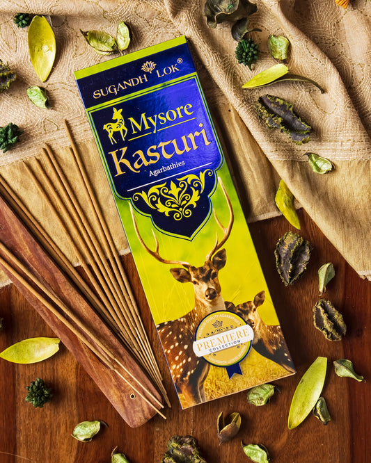 Mysore Kasturi Agarbatti Pack on a table surrounded by Kasturi