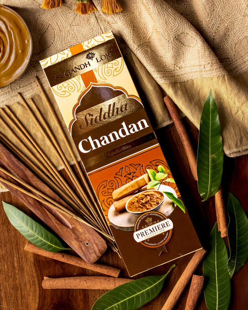 Siddha Chandan Agarbatti Box surrounded by sandalwood sticks